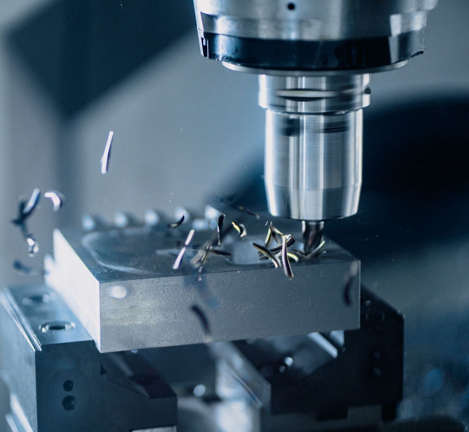End mill cutting an aluminium block, chips in flight